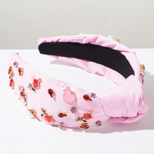 Detail of pink knotted headband with rose floral charms, pearls and crystals