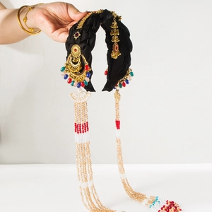 Detailed view of ornate ethnic headband with gold metal accents and colorful beads