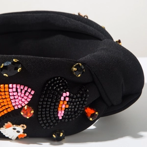Detail of knot headband with bead embroidery and ghost charm for Halloween