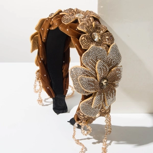 Detailed macro view of velvet headband featuring 3D rhinestone flowers and beaded tassels