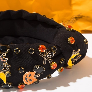 Détail serre-tête Halloween avec strass, chat noir, tête de mort et charms citrouille