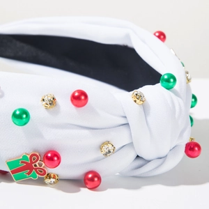 Dettaglio fascia per capelli nodo di Natale con strass, perle e ciondolo regalo