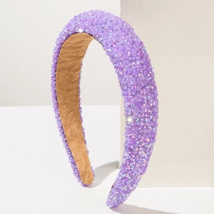 Macro detail of elegant purple headband encrusted with sparkling rhinestones and soft lining
