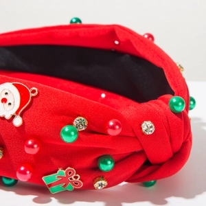 Dettaglio della fascia di Natale con ciondoli Babbo Natale e perle festive decorate