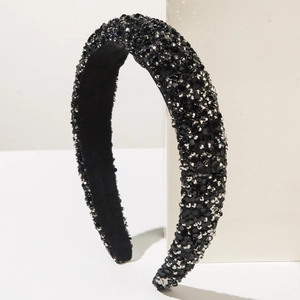 Close-up of black wide headband with sparkling gray rhinestones and non-slip inner lining