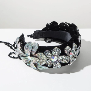 Macro detail of luxury velvet headband with five crystal flowers and fringe tassels