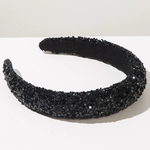 Detailed view of the sparkling black sequin headband with soft sponge padding and velvet lining