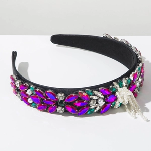 Close-up of baroque headband with colorful rhinestones, faux pearls and elegant tassels