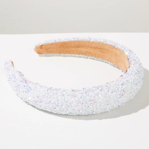 Detailed macro view of white iridescent sequined padded headband with brown velvet lining