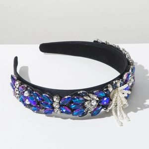 Detailed view of baroque headband with blue crystals and dangling pearl tassels
