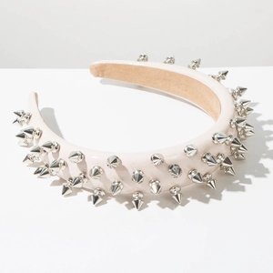 Detailed view of pink faux leather headband with silver punk studs and non-slip lining
