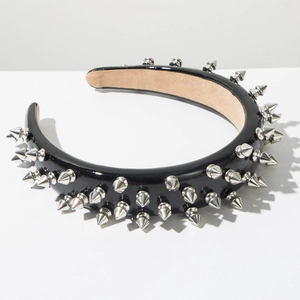 Close-up of punk style black leather headband featuring three rows of silver metal spikes