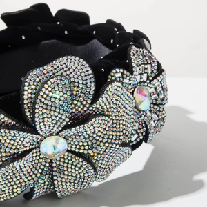 Close-up of velvet headband featuring intricate crystal flowers and beaded tassels