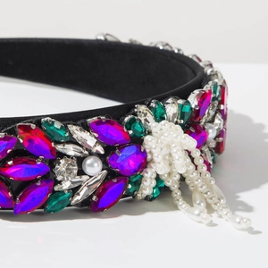 Detailed macro of Baroque headband featuring colorful rhinestones and pearl tassels