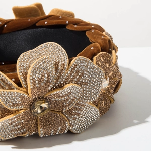 Detail of velvet braided headband with sparkling rhinestone flower and fringe tassel