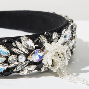 Detailed close-up of Baroque headband with rhinestones, black gems and pearl star charms