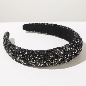 Detailed view of padded headband featuring sparkling black and silver rhinestones