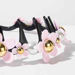 Détail d'un serre-tête à fleurs roses et perles avec pinces à cheveux de style