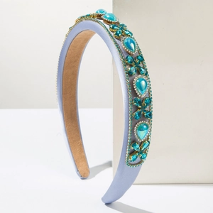Detail of luxury purple satin headband featuring turquoise gemstones and floral crystals