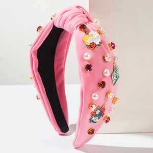 Pink knit Mother's Day headband with pearls, colorful gems, and MOM charms on white background