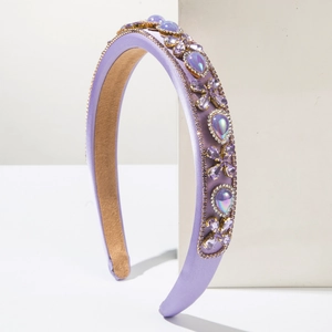Macro detail of luxury purple baroque headband with crystals and gold beaded edge