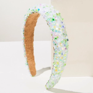 Detail of colorful star and heart sequins on white padded headband with suede lining