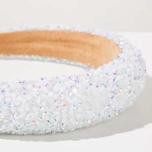Close-up of thick sponge headband featuring iridescent white sequins and velvet lining