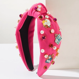 Close-up of pink headband with faux pearls, crystals and MOM themed enamel charms