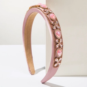 Detail of pink baroque headband with pear-shaped rhinestones and smooth satin fabric