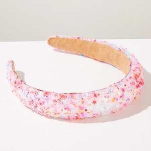 Detail of sponge headband featuring colorful star sequins and brown anti-slip suede lining
