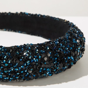 Detail of blue and black rhinestones on a thick sponge padded headband with soft lining