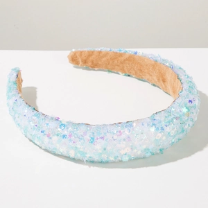 Close-up of iridescent blue sequins on sponge headband with soft brown suede lining
