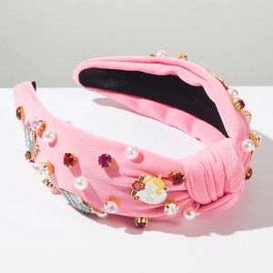Detail of pink knitted headband with MOM heart charm, pearls, and crystals for Mother's Day
