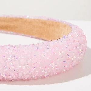Detailed macro view of pink iridescent sequin headband with soft padded texture