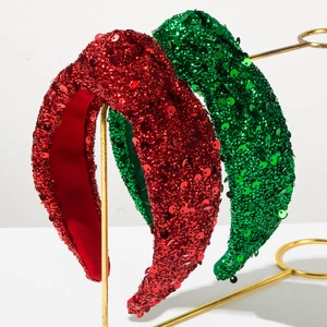 Detailed view of sparkly sequin padded headbands in festive red and green colors