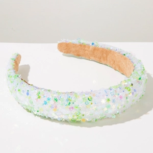 Detail of colorful star sequins under white mesh on a stylish sponge headband