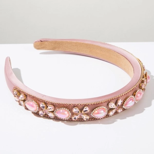 Detail of pink baroque headband featuring luxury rhinestones and gold chain trim