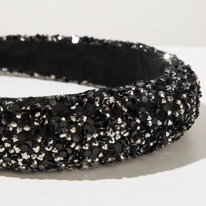 Detail shot of black headband with shimmering sequins and dark faceted rhinestones