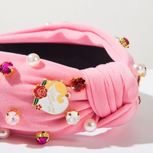 Detail of pink knit headband with pearls, crystals and Happy Mother's Day floral charm