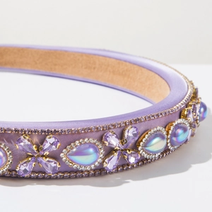 Detail view of purple Baroque headband with crystal flowers and luxury rhinestones