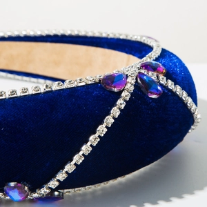 Close-up of deep blue velvet headband with sparkling rhinestones and teardrop jewels