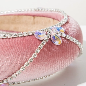 Detail of pink velvet headband with rhinestone chain trim and AB crystal accents