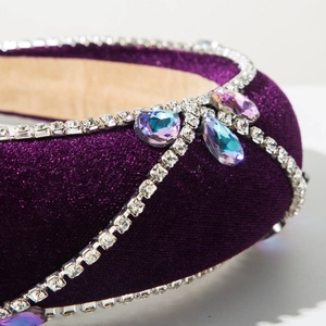 Detail of purple velvet headband with crystal chains and teardrop gemstones