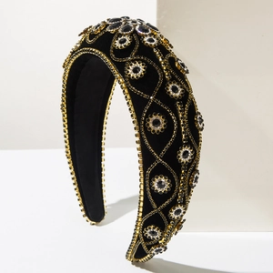 Detailed macro view of black velvet headband with champagne gold chains and dark rhinestones
