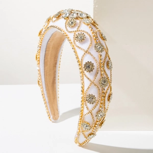 Macro shot of luxury white velvet headband with intricate gold wire and clear crystals