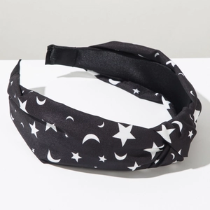 Detail of Halloween knot headband with white star and moon prints on black fabric