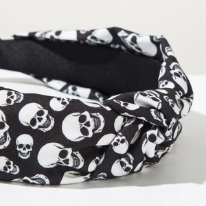 Detailed macro view showing the fabric texture and skull pattern on the headband knot