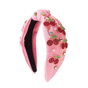 Pink fabric knot headband with rhinestone cherry patterns and white pearl embellishments