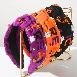 Detail of beaded Halloween headbands with Trick or Treat letters and holiday charms
