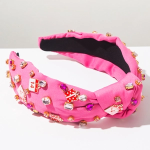 Detail of pink knotted headband with rhinestones, heart charms and calendar pendants